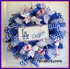 a los angeles dodgers wreath is hanging on a door with blue and white deco mesh