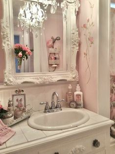 a white sink sitting under a mirror in a bathroom