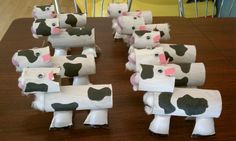 several cows made out of toilet paper on a table