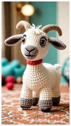 a small crocheted sheep is standing on the floor