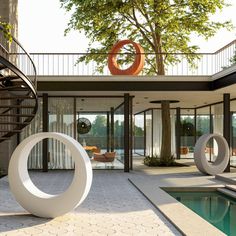 a large white sculpture sitting in the middle of a room next to a swimming pool