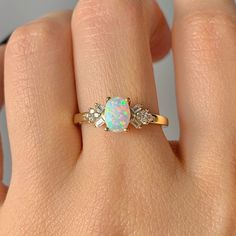 Gorgeous vintage inspired Australian opal ring ✧ Sterling silver (925) or 14K Gold or 14K Rose gold ✧ Accented with natural quartz diamonds This gorgeous, timeless ring features a stunning Australian opal and natural crystals. ✧Stone: Natural Gemstone ✧Shape: Oval ✧Carat Weight: 0.53ct.(approx.) ✧Gemstone Origin: Australia ✧ Sizes 3.75-11.25 ✧ This ring set will arrive ready to gift in a Kherish Box. ✧ Due to the nature of the handmade process, each piece may slightly vary in color, size, shape, Gold Ring Stacking, Raw Opal Ring, Australian Opal Ring, Opal Band, Timeless Ring, Diamond Rings Design, Ring Opal, Opal Ring Gold, Jewelry Dainty