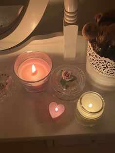 some candles are sitting on a table next to other items that have been placed around them