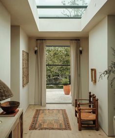 a room that has a skylight in the ceiling and a rug on the floor