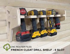 there are many different tools hanging on the wall in this room, including drillers and screwdrivers