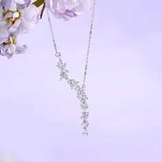 An elegant flower wave for sophisticated looks. People believe happiness comes when the Wisteria flower blooms. Wisteria flower is a purple flower symbolizing romance in most cultures. It is a climbing plant that represents the feelings of reluctance between lovers, and the bond between each other. Our jewelry designs follow the femininity of the flower as it sways in the breeze, like an elegant lady swings in her satin silk dress. Material: 925 Sterling Silver and White Cubic Zirconia Stones Ch Silk Dress Material, Wisteria Flower, Satin Silk Dress, Elegant Lady, Climbing Plants, Elegant Flowers, This Is Love, Necklace Online, Satin Silk