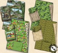 an assortment of quilts and bedding with animals in the woods on them, including green