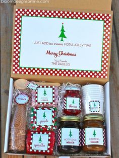 a box filled with jams and cookies on top of a wooden table next to a sign