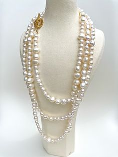 This luxurious necklace features two hundred hand-strung freshwater pearls with a beautiful lustre, meticulously crafted on a 100% silk threader and finished with an exquisite, secure gold OT clasp. A truly unique design allows for multiple ways of wearing the necklace, including three layers, two layers, twisted as a single layer, or any other creative arrangement that suits your personal style. This versatility ensures that you can effortlessly adapt the necklace to complement various outfits Luxury Double Strand Pearl Necklace, Luxury Double Strand Pearl Necklace For Gift, Luxury White Double Strand Pearl Necklace, Luxury Multi-strand Pearl Chain Necklace, Luxury White Single Strand Pearl Necklace, Luxury Single Strand Baroque Pearl Jewelry, Luxury Single Strand Pearl Necklace, Luxury Long Pearl Necklace With Charm, Luxury Long Pearl Chain Necklace