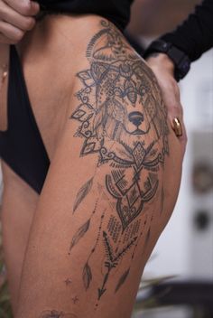 a woman with a tattoo on her thigh