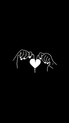 two hands holding a heart in the dark