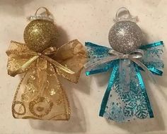 two christmas ornaments sitting on top of a table