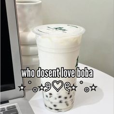 a cup of coffee sitting on top of a table next to a laptop computer with the caption who doesn't love boa