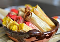 a wooden bowl filled with food on top of a table