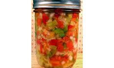 a jar filled with lots of different types of vegetables