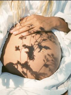 a pregnant woman's shadow on her stomach