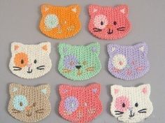 crocheted cat coasters are shown in different colors