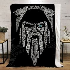 a blanket with an image of a man's face and beard on the front