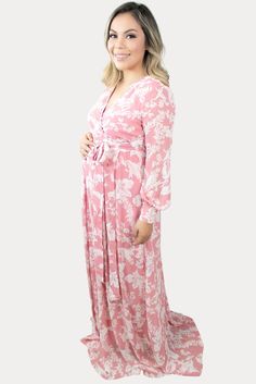 This is the perfect pink floral maternity maxi. Features a gorgeous pink color with a standout white floral print. The sweetheart neckline is perfect for nursing, long loose sleeves, and a tie waistline to keep you comfy! An ideal floral baby shower maxi, date night dress, or just because. Designed for wear throughout all nine months of pregnancy and beyond!