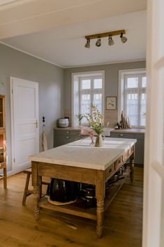 a kitchen with a center island and wooden floors