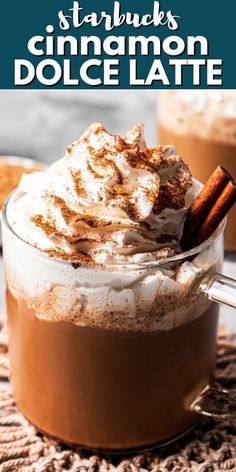 a close up of a cup of hot chocolate with whipped cream and cinnamon on top