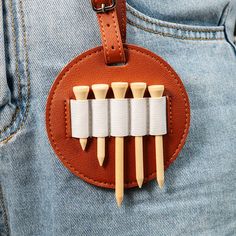 four toothpicks sticking out of the back pocket of someone's jean pants