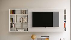 an entertainment center with bookshelves and a flat screen tv mounted on the wall