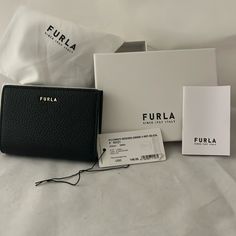 Nwt Authentic Furla Wallet In Black. 4 Slots For Credit Cards, A Zippered Coin Case & Slots For Paper Bills And 2 Larger Slots For Things Like Health Care Or Membership Cards. 4 3/4 In Across, 3 1/2 In Length, 3/4 Inches In Depth This Wallet Is Brand New And Perfect For Your Smaller Bags. Stylish, Pebbled Leather. This One Won't Last!! Ships With 1 Day! Includes Furla Branded Box & Dust Bag Smoke Free/Pet Free Home Elegant Black Compact Trifold Wallet, Elegant Black Bifold Coin Purse, Elegant Compact Trifold Wallet, Elegant Black Trifold Wallet, Elegant Black Trifold Wallet For Evening, Elegant Black Trifold Evening Wallet, Elegant Black Coin Purse For Everyday Use, Black Trifold Wallet For Evening, Formal Black Trifold Wallet