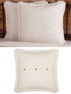 two white pillows with gold buttons on them