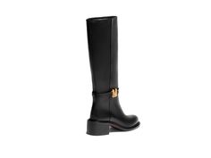 Introducing the Genevieve Rider – a knee-high rider boot that embodies elegance and equestrian charm. Featuring a classic round toe silhouette and adorned with a sophisticated "M" ornament, the Genevieve offers a timeless look. Interior pull tabs ensure easy wear, while its design draws inspiration from traditional riding boots. Elegant Knee-high Riding Boots, Rider Boots, Boot Straps, Loafer Sneakers, Monk Strap, Boot Sandals, Shoe Care, Easy Wear, Designs To Draw