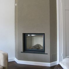 a room with a fire place in the corner