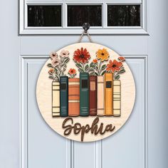 a door sign with books and flowers on it