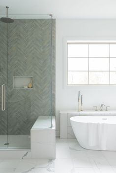 a bathroom with a tub, sink and shower stall in the middle of the room