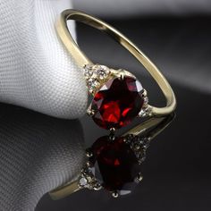 A strikingly beautiful Red Garnet ring surrounded by Six Diamonds.Flaunting a beautiful natural gemstone in a classic and elegant design to wear everyday.Handmade by artist in solid gold with an utmost attention to details.Beautifully finished with Each diamond and gemstone handpicked and inspected for the best color and depth.Get this ring today and enjoy it forever!Ring Features......................• Made to Order, perfectly finished, Fast shipping fully insured and traceable online.• Made in Luxury Ruby Ring With Gemstone Accents, Classic Promise Crystal Ring With Gemstone, Elegant Promise Birthstone Ring With Gemstone Accents, Exquisite Ruby Ring, Elegant Gold Halo Ring With Gemstone, Dazzling Oval Ruby Ring, Elegant Yellow Gold Gemstones With Center Stone, Elegant Gold Gemstones With Center Stone, Elegant Round Cut Ruby Ring Gift