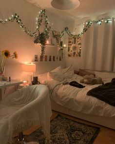 a bed room with a neatly made bed next to a desk and window covered in lights