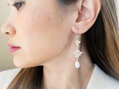 "These boho bridal earrings are perfect for the modern bride looking to add a touch of elegance and sparkle on her wedding day, bridal shower or wedding rehearsal.   The addition of the lustrous creamy white freshwater pearls provides a classic and timeless touch that will definitely be cherished for years to come. Details: - glass crystals with gold plated setting - 14K gold filled ear wires - genuine freshwater pearls Dimension: Earrings : 1.25 inches x 2.5 inches long PACKAGED READY FOR GIFTI Elegant Wedding Cluster Earrings With Ear Wire, Elegant Wedding Flower Earrings With Ear Wire, Delicate Bridal Earrings With Ear Wire For Wedding, Delicate Dangle Earrings For Mother Of The Bride, Wedding Cluster Earrings With Ear Wire, Delicate Chandelier Earrings For Wedding, Flower Drop Earrings For Wedding, Wedding Flower Drop Earrings For Pierced Ears, Wedding Flower Drop Earrings