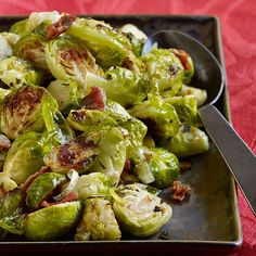 brussel sprouts with bacon and onions in a black plate on a red tablecloth