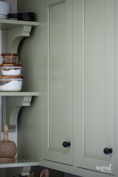 the shelves in this kitchen are filled with bowls and containers on top of each other