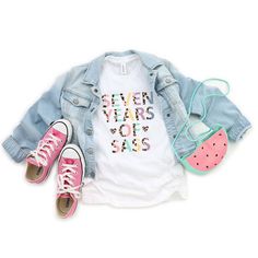 a pair of pink converse shoes and a white shirt with the word prek on it