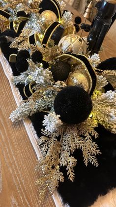 black and gold christmas decorations on a table