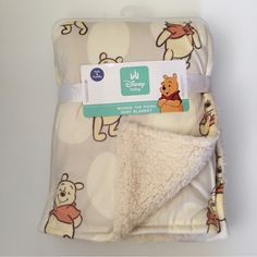 winnie the pooh baby blanket with sherpot on it and white polka dot background