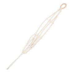 three strands of white pearls with a gold clasp on a white background the beads are attached to a wooden hook