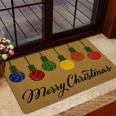 a door mat with christmas lights on it next to a potted plant and window