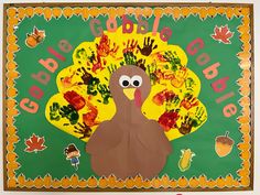 a turkey made out of handprints on a green and yellow background with leaves