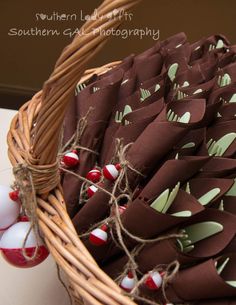 a wicker basket filled with red and white ornaments