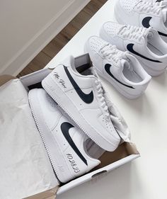 four pairs of nike air force sneakers are in a box on the floor next to each other