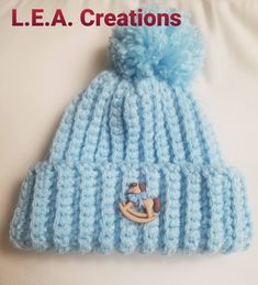 a blue knitted hat with a button on it