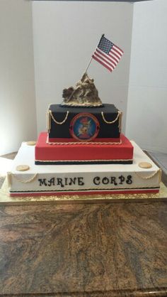 there is a cake made to look like a marine corp boat with an american flag on top