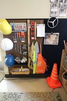 there is a bulletin board with various items on it and balloons in the air next to it