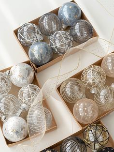 three boxes filled with ornaments on top of a table